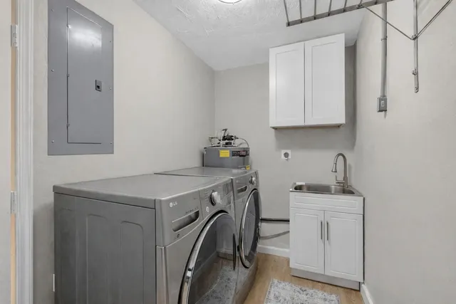 a utility room with sink dryer and washer