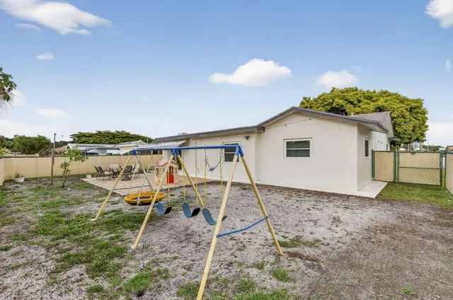 a view of a backyard with table and chairs