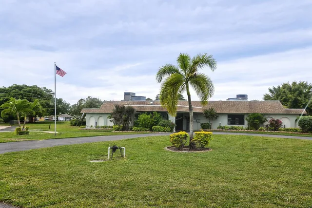 an aerial view of residential houses with outdoor space and parking