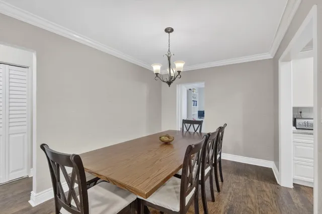a view of a dining room with a table and chairs