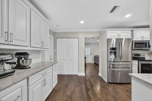 a kitchen with a refrigerator and a sink
