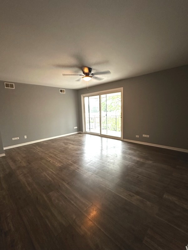 11036 Kilpatrick Avenue, Unit 3SW Oak Lawn, IL 60453 - Photo 3 of 9 a view of an empty room with wooden floor and a window