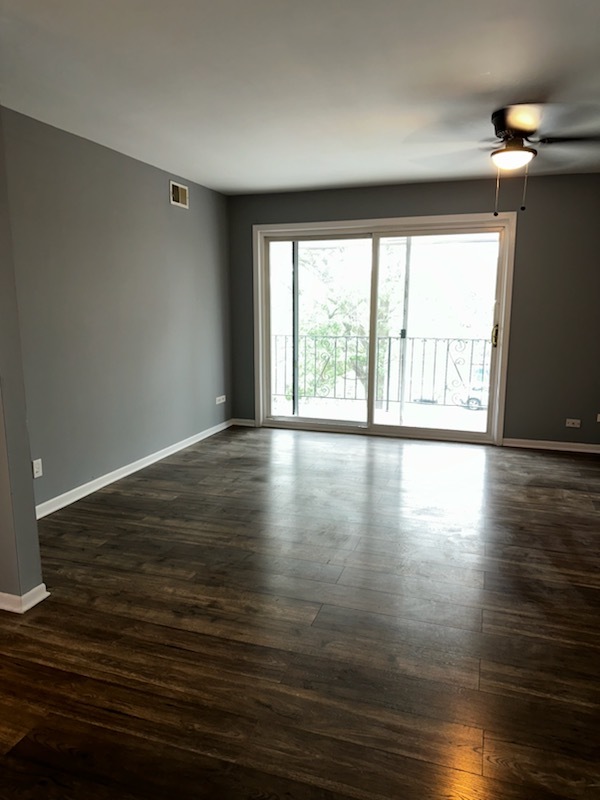 11036 Kilpatrick Avenue, Unit 3SW Oak Lawn, IL 60453 - Photo 4 of 9 a view of an empty room with wooden floor and a window