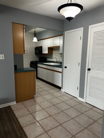 11036 Kilpatrick Avenue, Unit 3SW Oak Lawn, IL 60453 - Photo 5 of 9 a kitchen with stainless steel appliances granite countertop a refrigerator and a sink