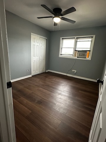 11036 Kilpatrick Avenue, Unit 3SW Oak Lawn, IL 60453 - Photo 7 of 9 an empty room with wooden floor fan and windows