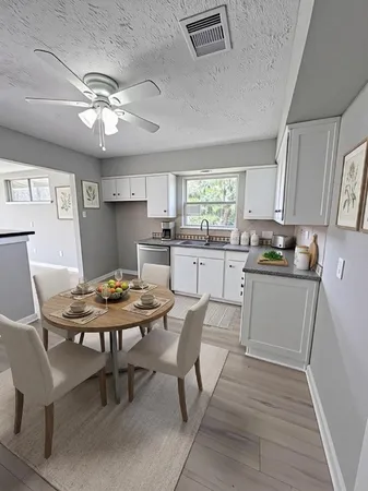 a kitchen with a table chairs and a refrigerator