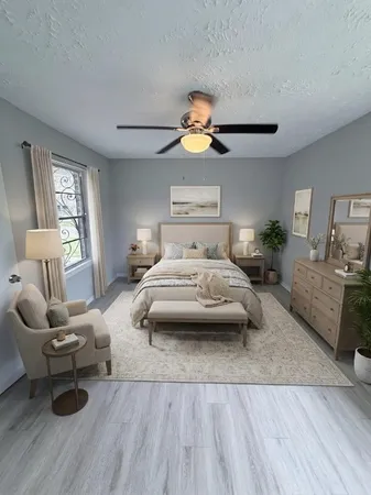 a bedroom with furniture and a wooden floor