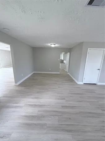 a view of an empty room and wooden floor