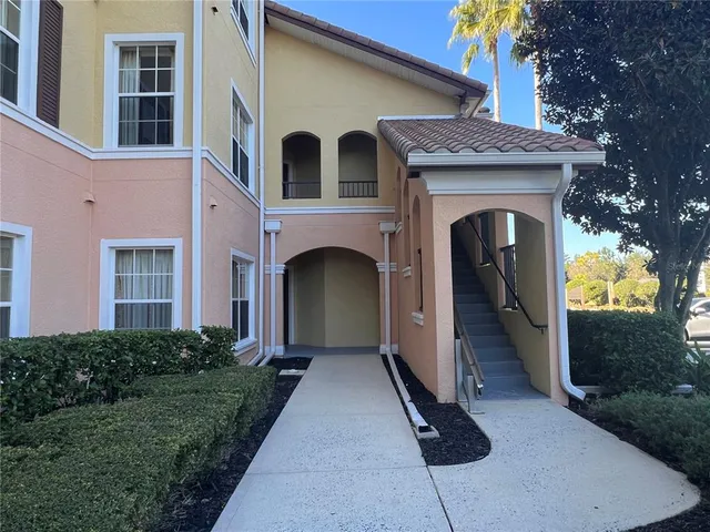 a front view of a house with yard and green space