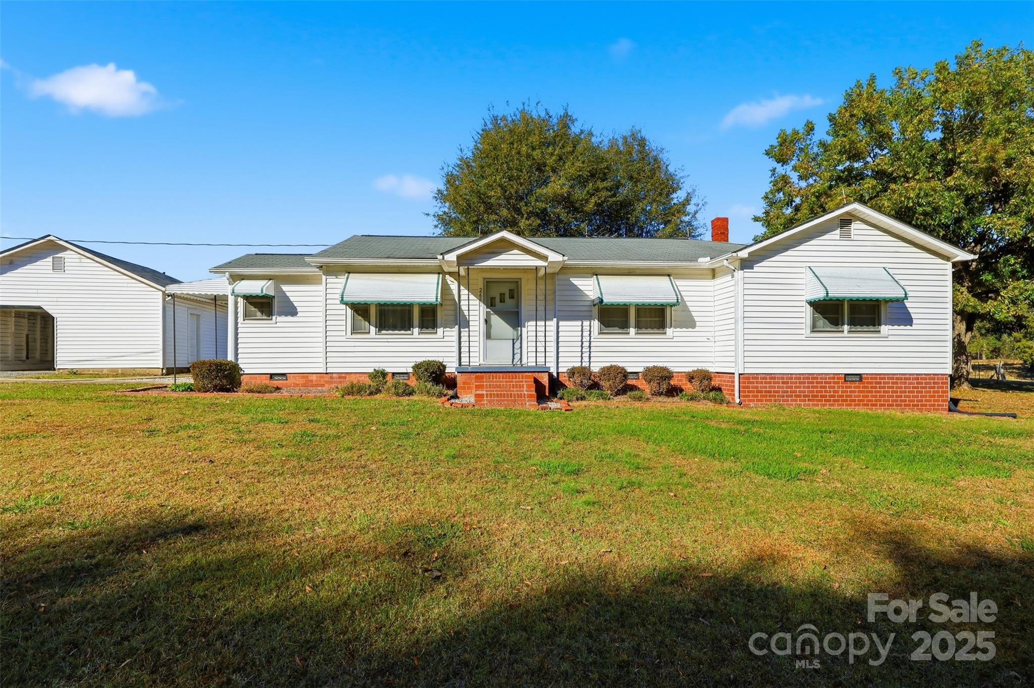 a front view of house with yard and green space