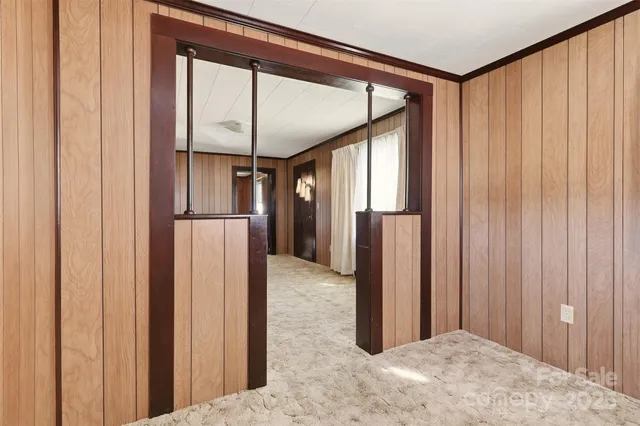 a bathroom with a refrigerator and a window