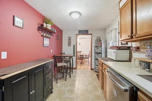 a kitchen with granite countertop a sink cabinets and stainless steel appliances