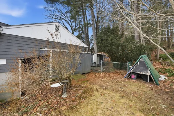 a view of wooden house with a yard