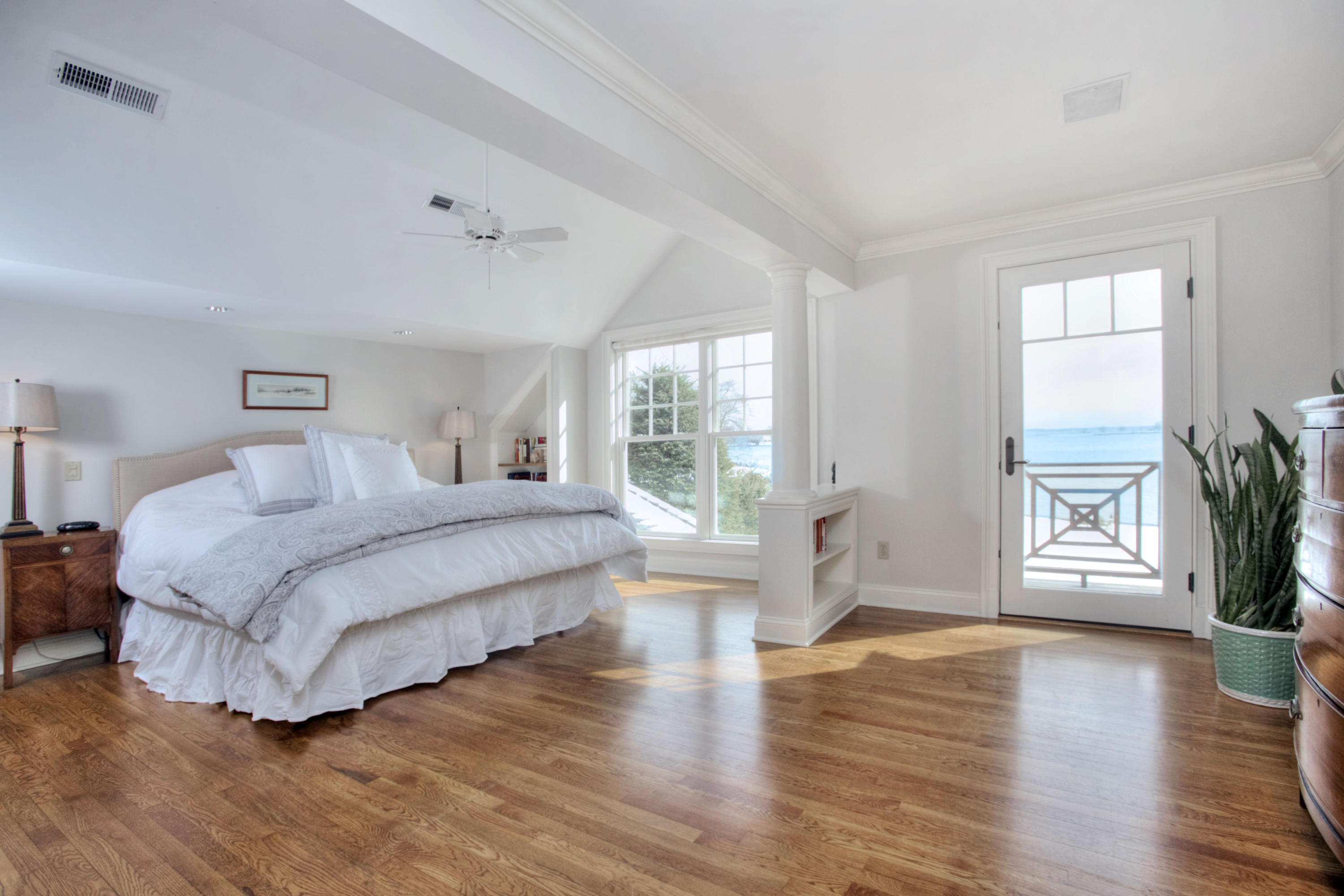 9 Seagate Road Darien, CT 06820 - Photo 18 of 32 a spacious bedroom with a large bed and a wooden floor