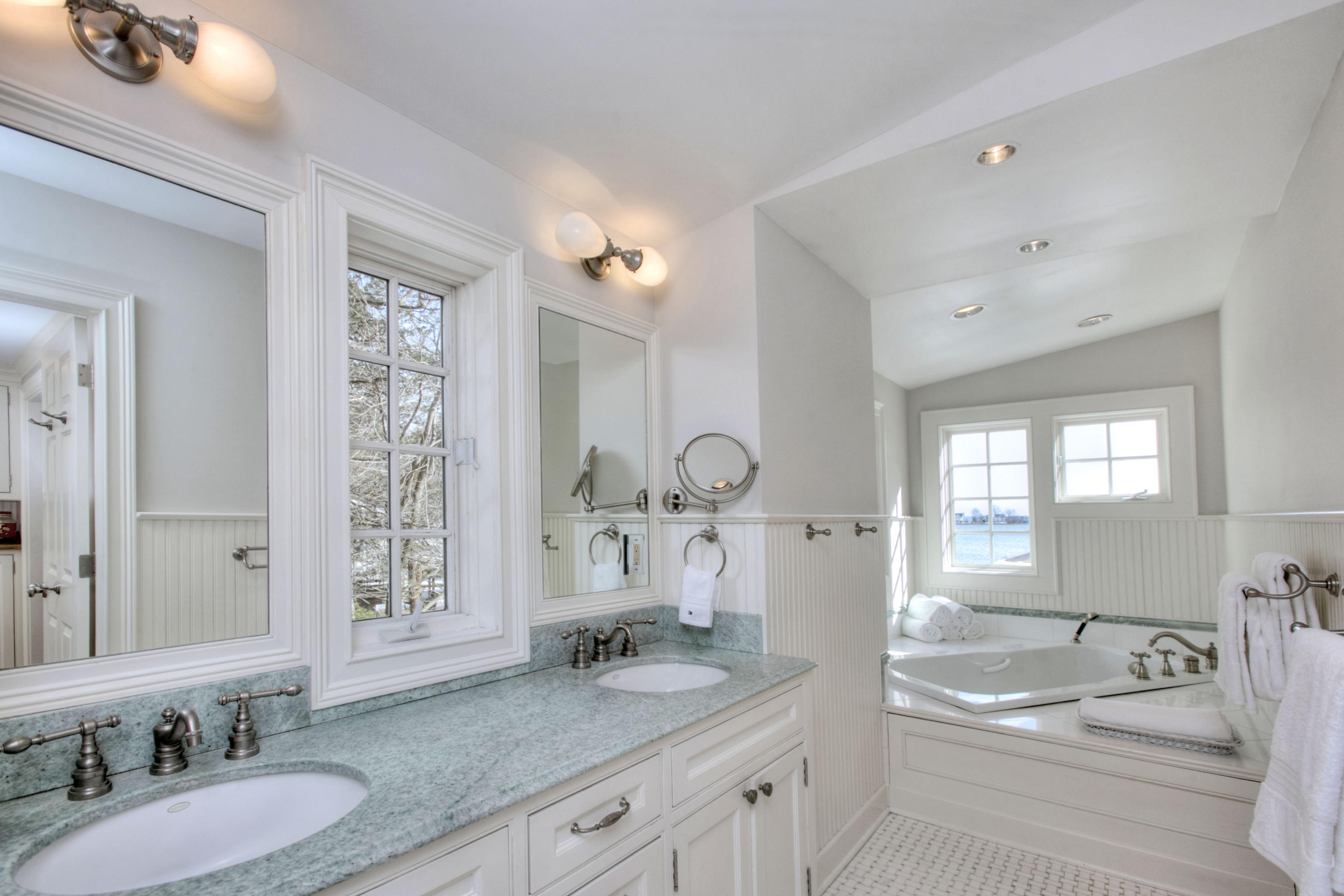 9 Seagate Road Darien, CT 06820 - Photo 20 of 32 a spacious bathroom with a granite countertop tub sink and mirror