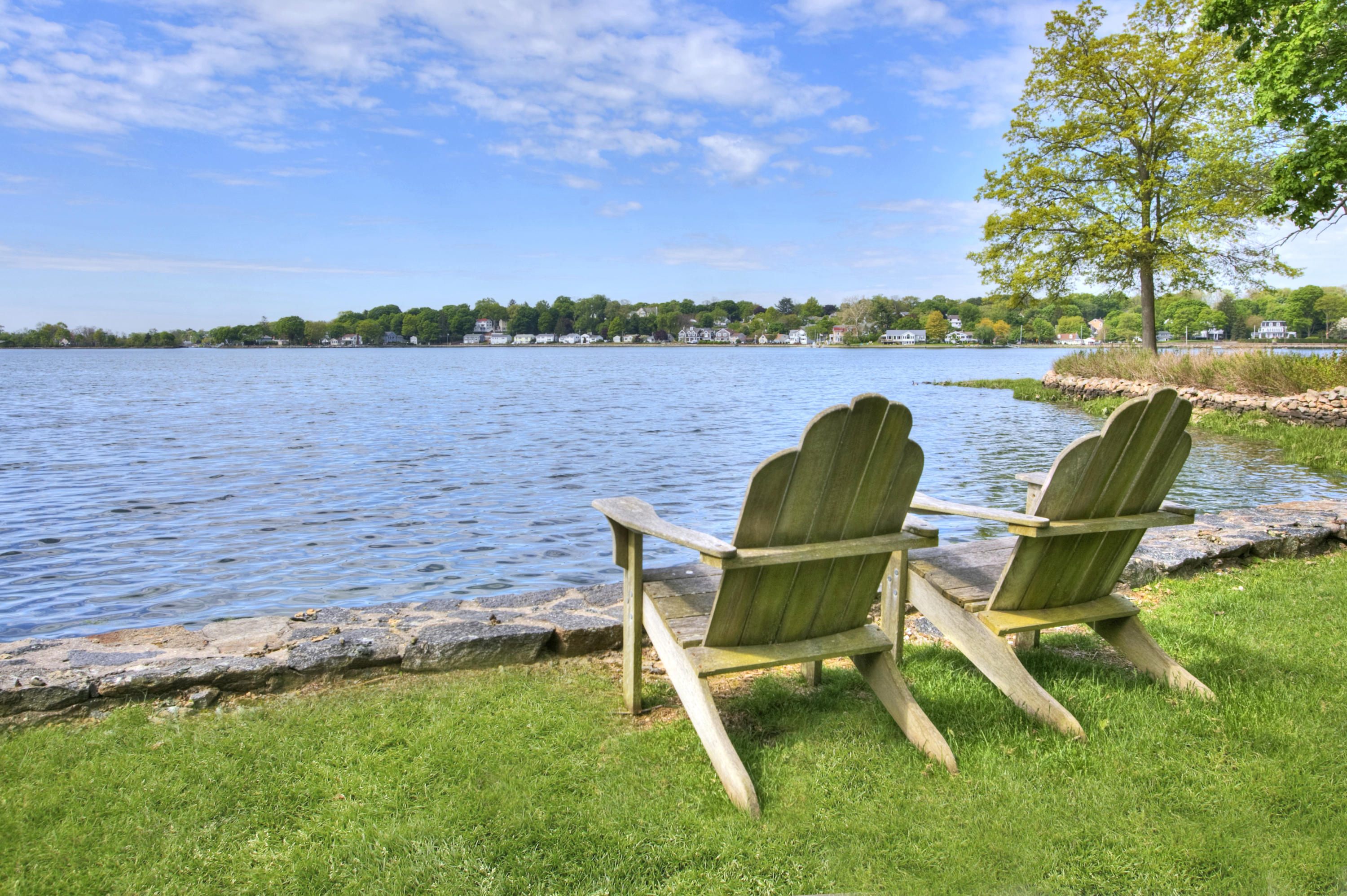 9 Seagate Road Darien, CT 06820 - Photo 6 of 32 a view of a lake with table and chairs
