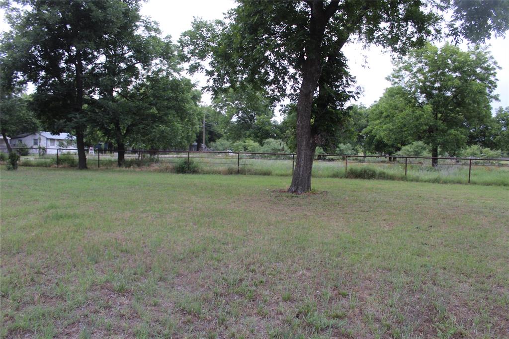 510 Hamby Road Clyde, TX 79510 - Photo 7 of 23 Expansive green lawn with mature trees and a perimeter fence