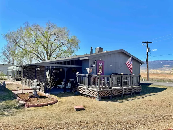 a wooden bench sitting in front of a building