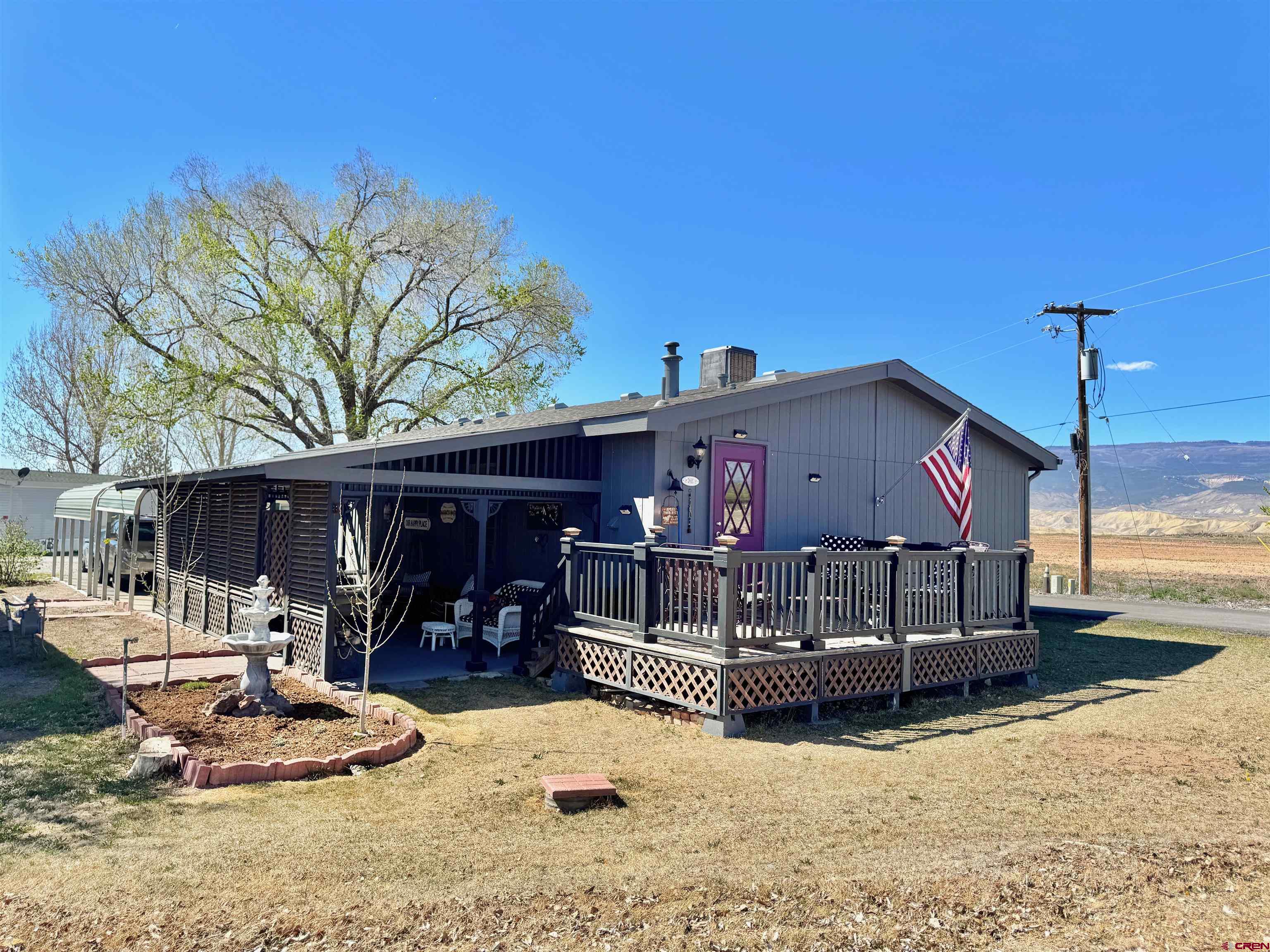 20020 Kenosha Road Austin, CO 81410 - Photo 1 of 40 a wooden bench sitting in front of a building