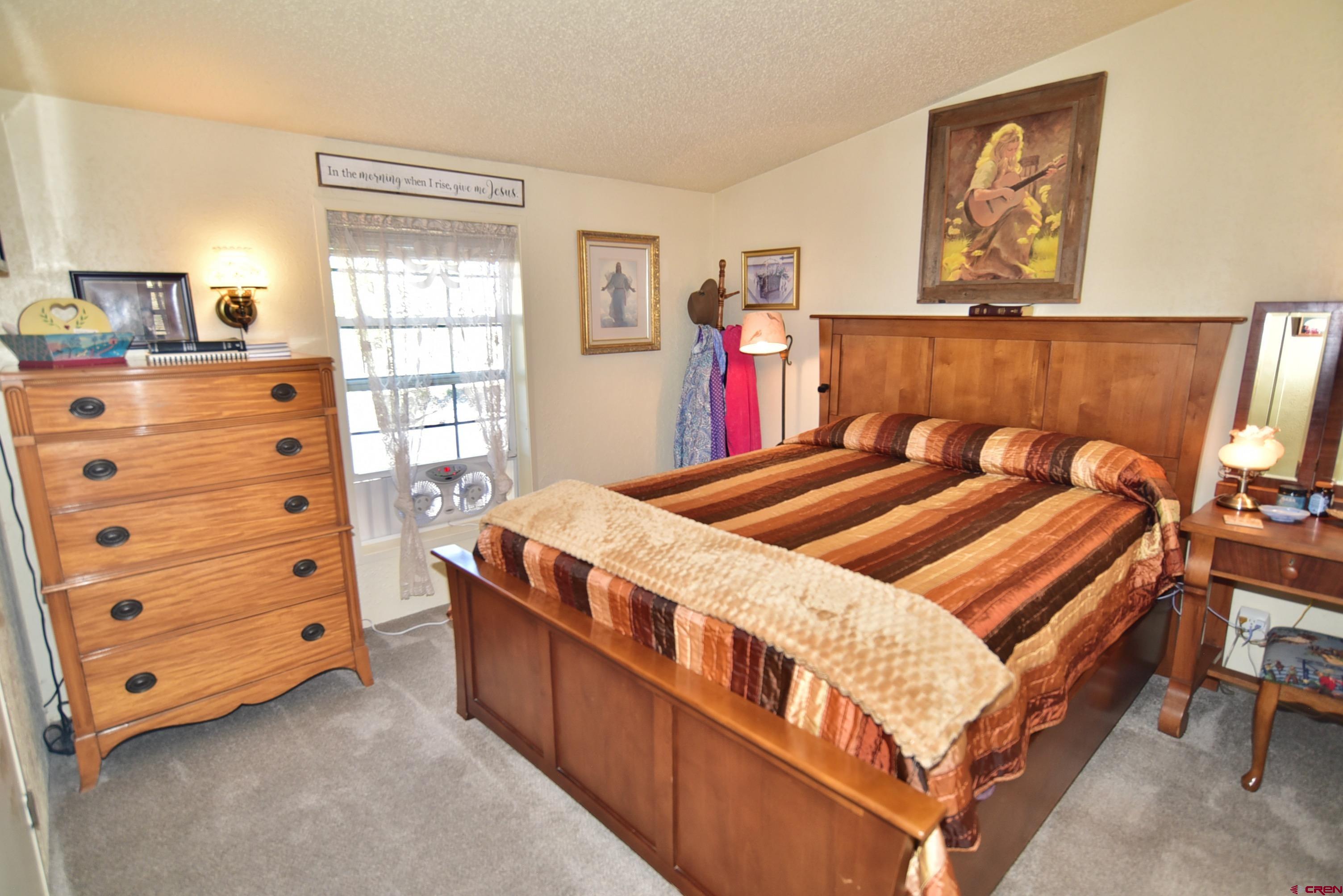 20020 Kenosha Road Austin, CO 81410 - Photo 14 of 40 a bedroom with a bed and a window