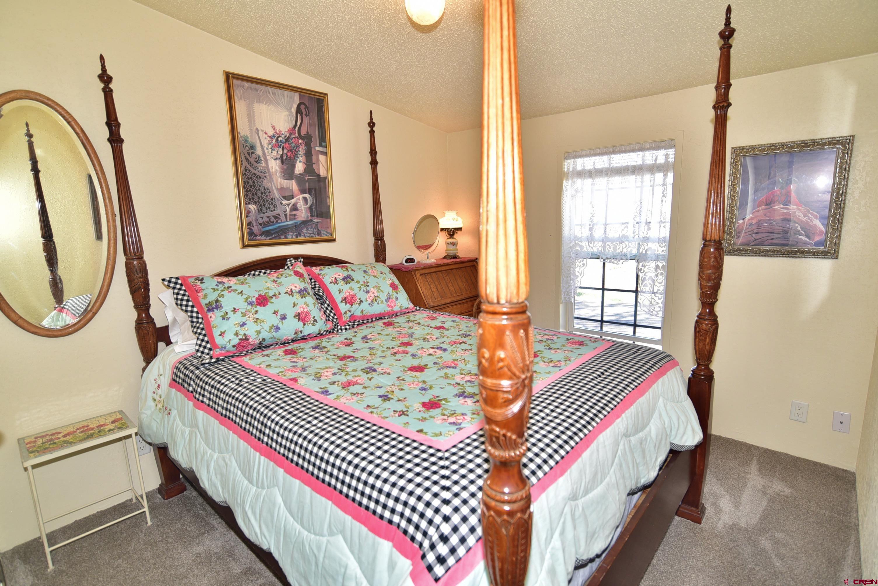 20020 Kenosha Road Austin, CO 81410 - Photo 17 of 40 a bedroom with a bed and a painting on the wall
