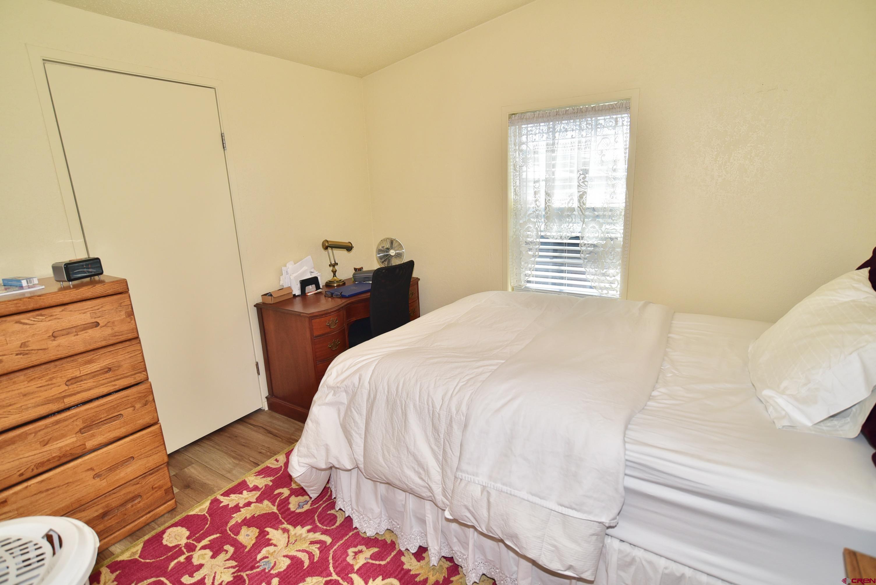 20020 Kenosha Road Austin, CO 81410 - Photo 18 of 40 a bedroom with a bed and a dresser