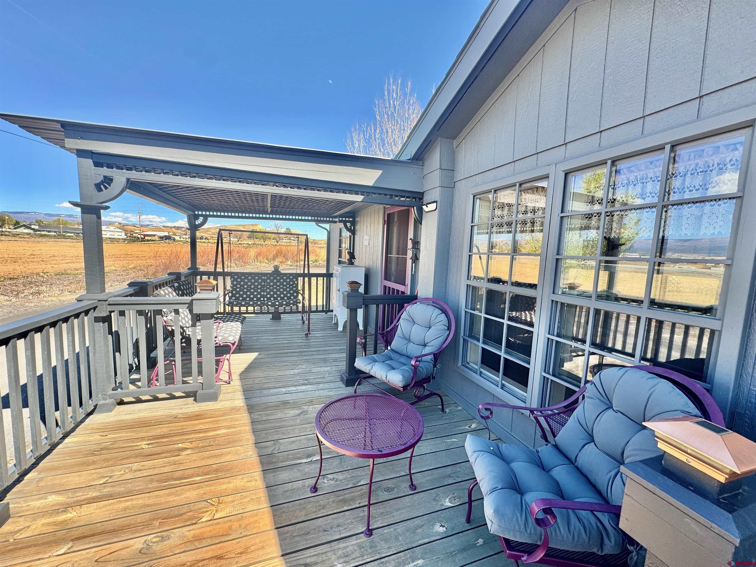 20020 Kenosha Road Austin, CO 81410 - Photo 24 of 40 a living room with furniture a rug and a floor to ceiling window