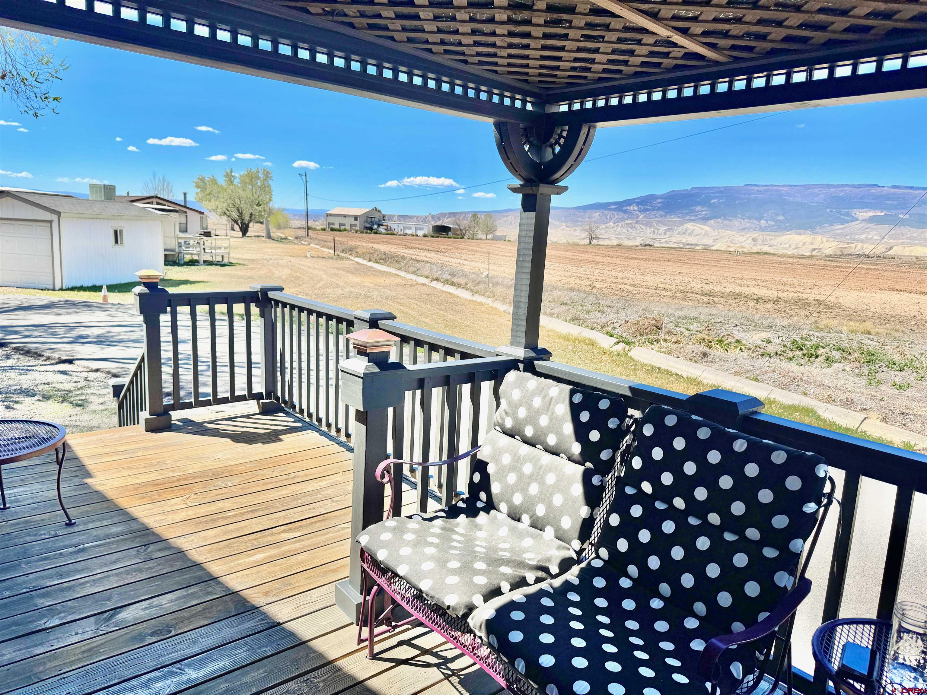 20020 Kenosha Road Austin, CO 81410 - Photo 26 of 40 a view of a roof deck with wooden floor and fence