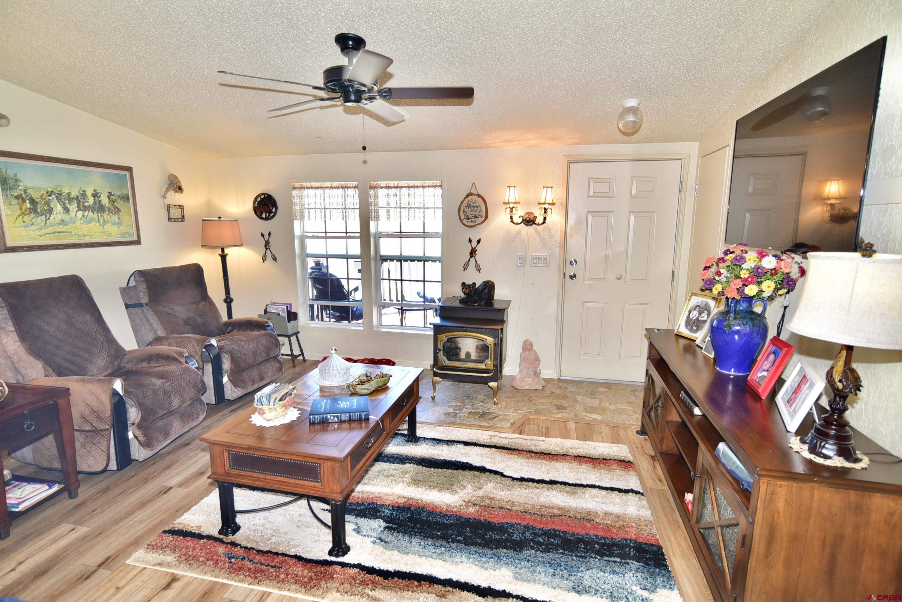 20020 Kenosha Road Austin, CO 81410 - Photo 6 of 40 a living room with furniture and a chandelier