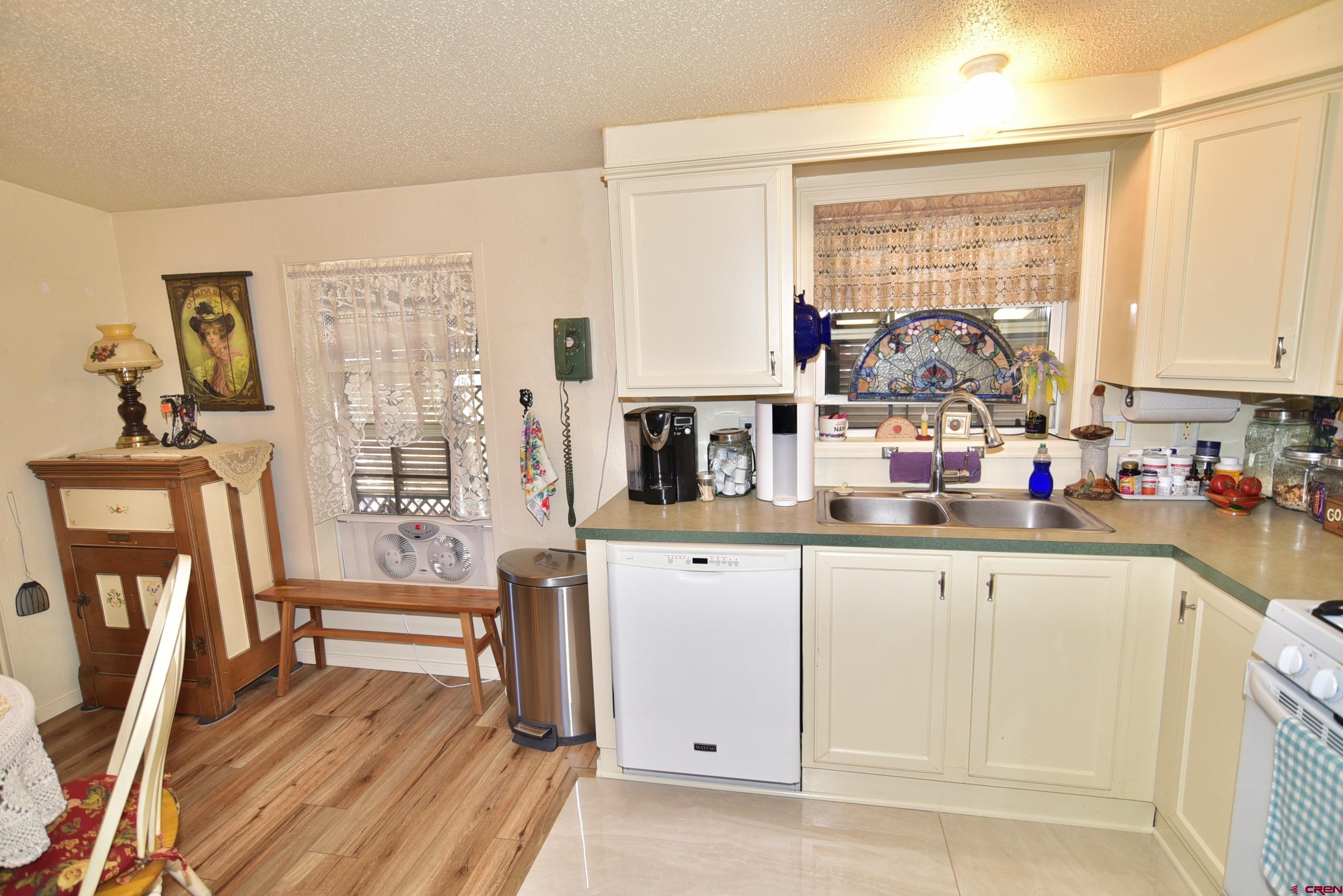 20020 Kenosha Road Austin, CO 81410 - Photo 9 of 40 a kitchen with stainless steel appliances wooden floor and a window