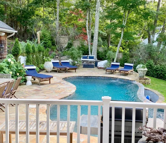 a view of a patio with chairs and plants
