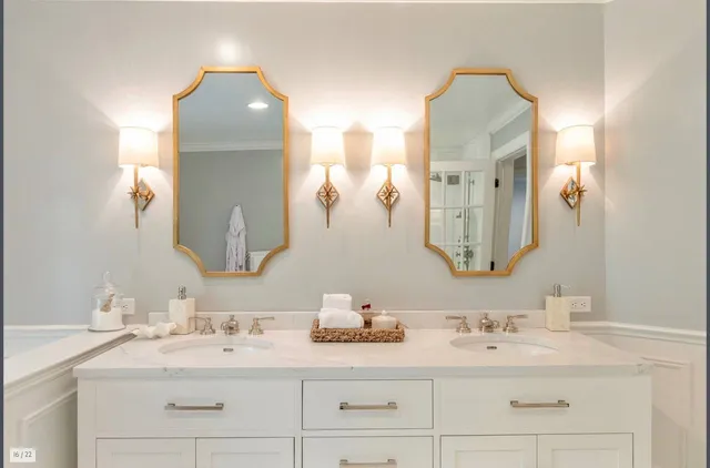 a bathroom with double vanity sinks and a mirror
