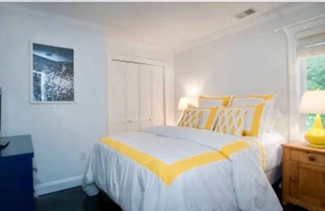 a bedroom with a bed and a window