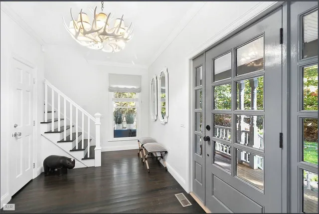 a view of an entryway with wooden floor