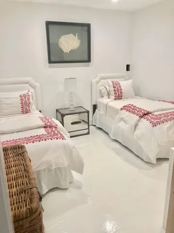 a bedroom with a bed and a painting on the wall