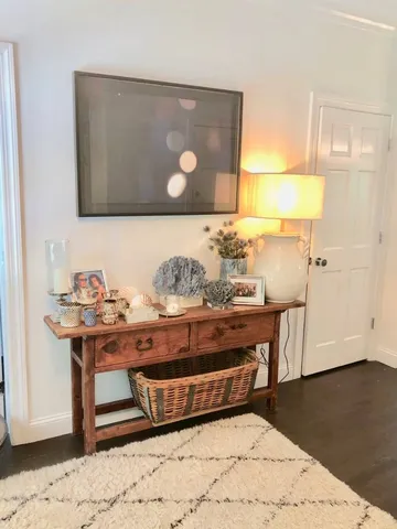 a living room with stainless steel appliances kitchen island granite countertop furniture and wooden floor