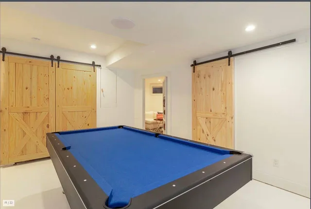 a room with pool table and a glass door