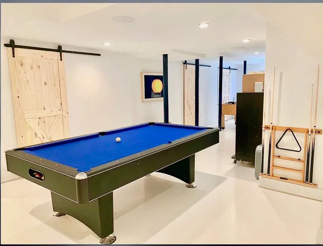 a room with furniture and air hockey table