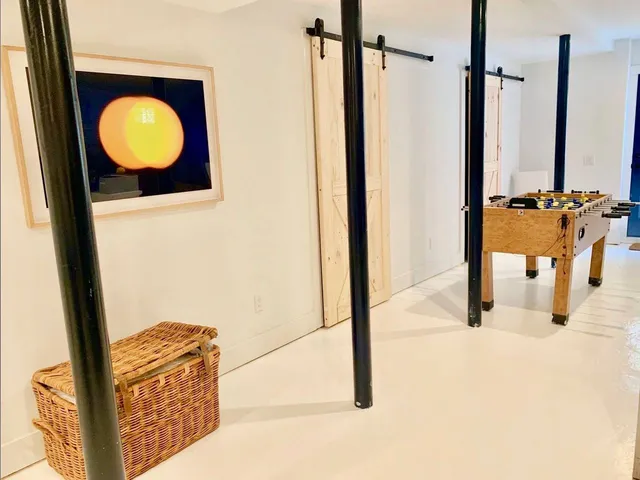 a dining room with furniture and a floor to ceiling window