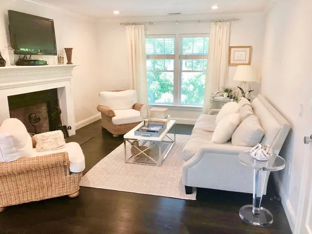 a living room with furniture and a fireplace