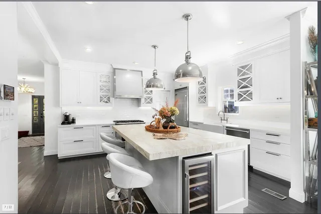 a kitchen with white cabinets and white appliances