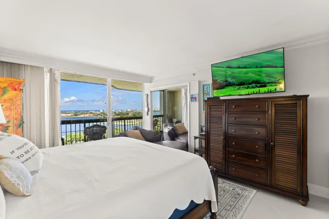 a large bedroom with a bed and large window