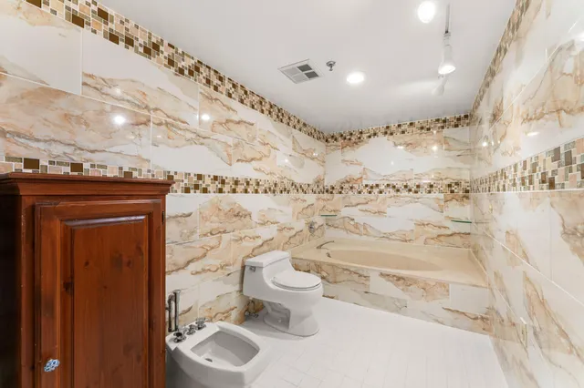a bathroom with a toilet sink and mirror