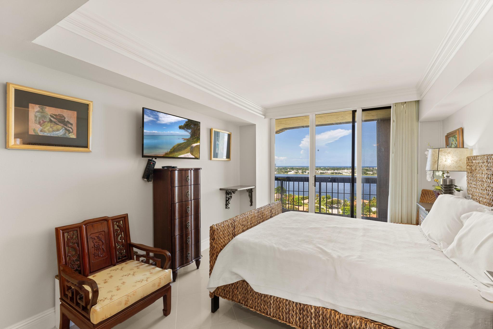 1900 Consulate Place, Unit 2002 West Palm Beach, FL 33401 - Photo 20 of 29 a bedroom with a bed and window