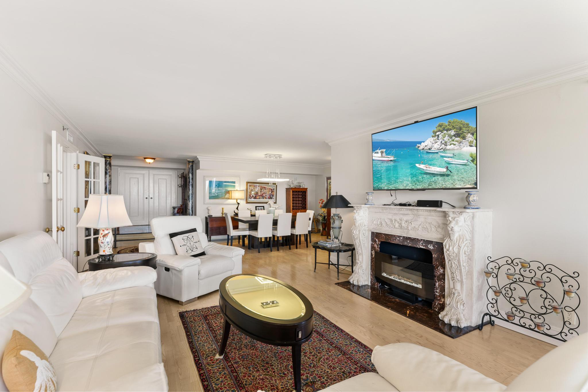 1900 Consulate Place, Unit 2002 West Palm Beach, FL 33401 - Photo 4 of 29 a living room with furniture and a fireplace