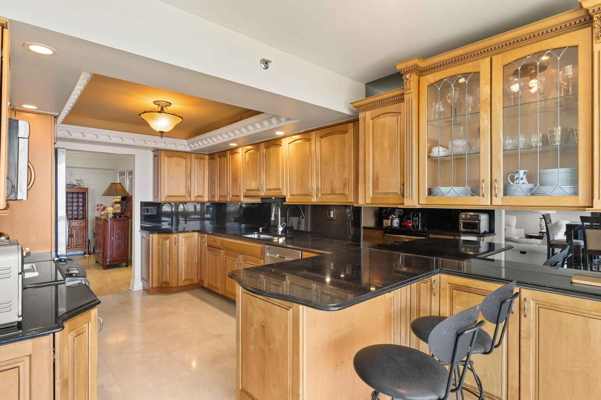 1900 Consulate Place, Unit 2002 West Palm Beach, FL 33401 - Photo 8 of 29 a kitchen with large windows and refrigerator