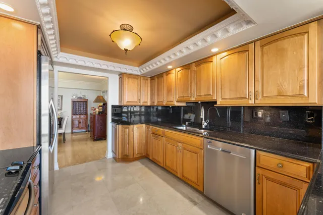 a kitchen with stainless steel appliances granite countertop a sink and cabinets