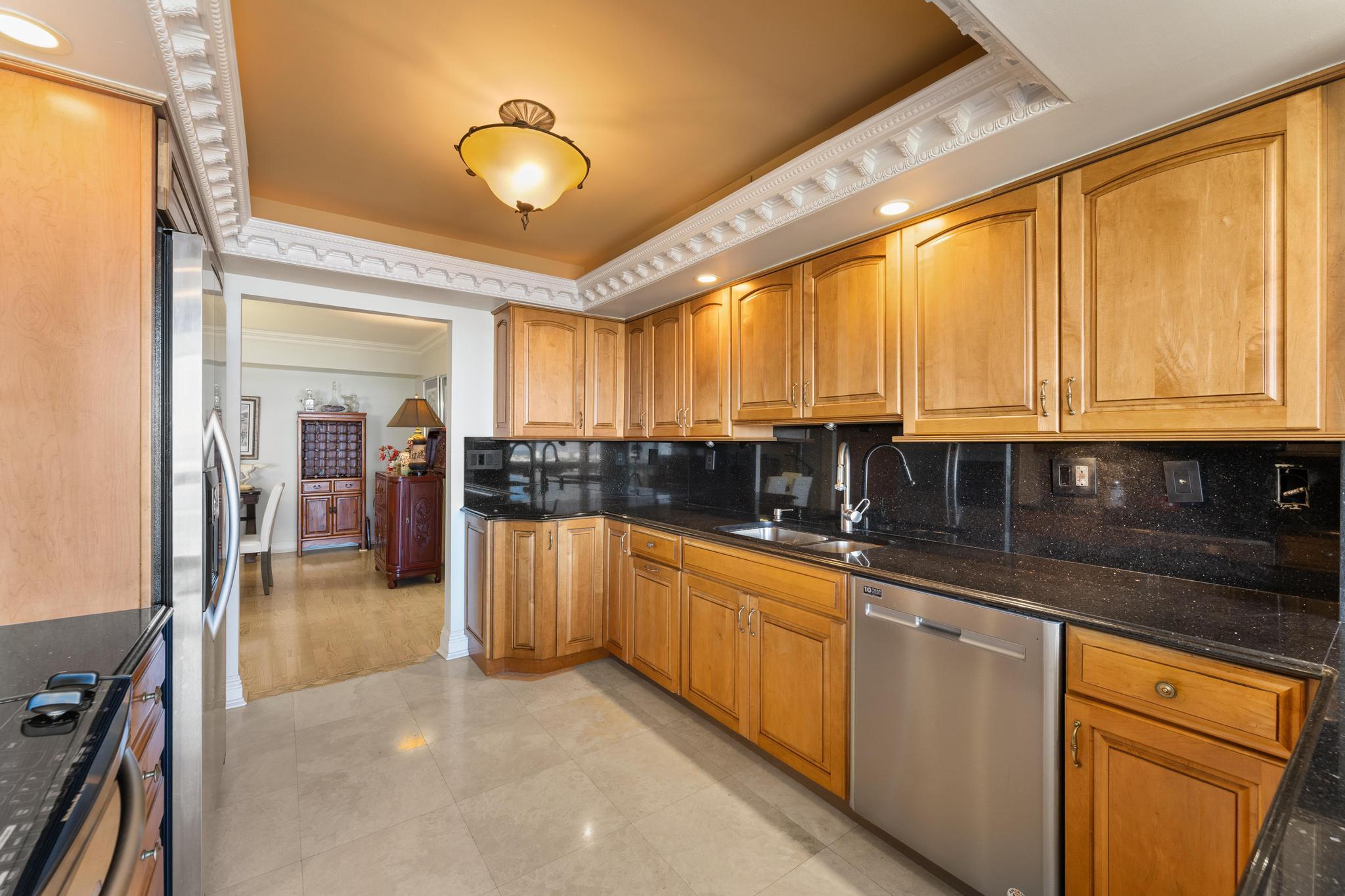 1900 Consulate Place, Unit 2002 West Palm Beach, FL 33401 - Photo 10 of 29 a kitchen with stainless steel appliances granite countertop a sink and cabinets