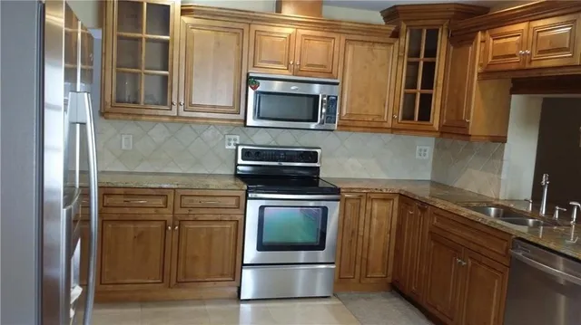 a kitchen with a sink and steel cabinets