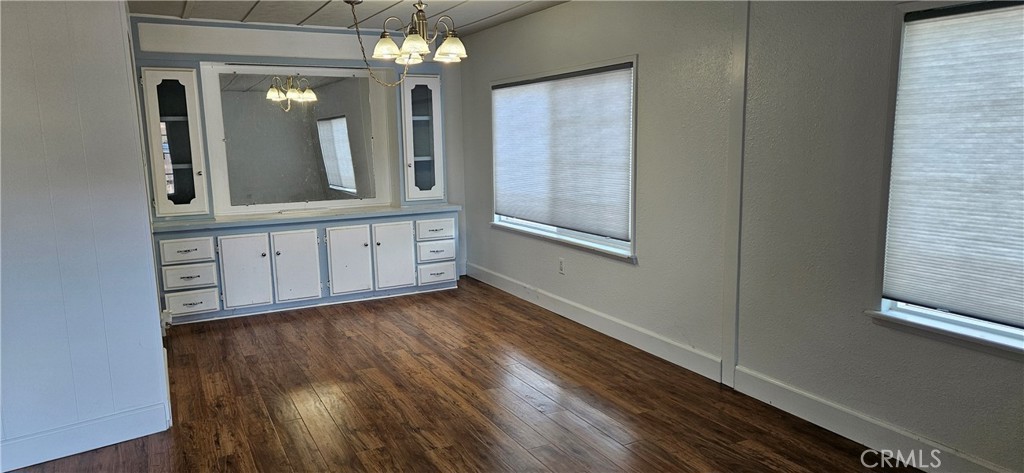 2920 Clark Road, Unit C12 Oroville, CA 95965 - Photo 4 of 17 a view of a hallway with wooden floor and a large mirror